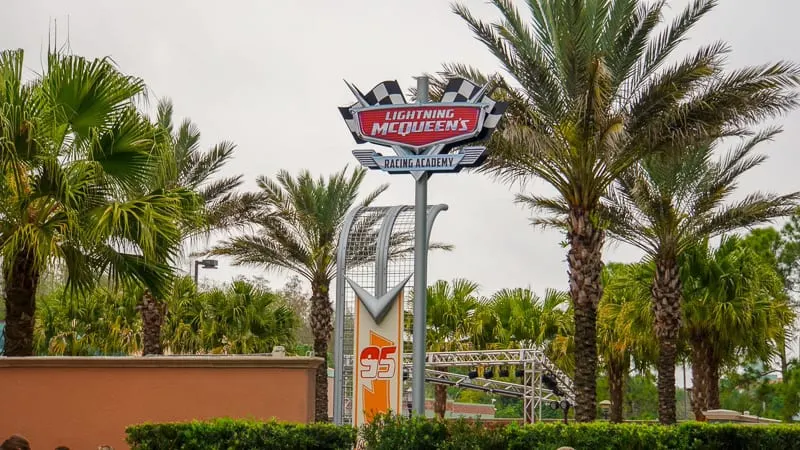 Lightning McQueen's Racing Academy Construction Update March 2019 tall shot of attraction sign