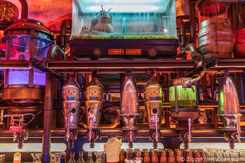 taps behind the bar in Oga's Cantina