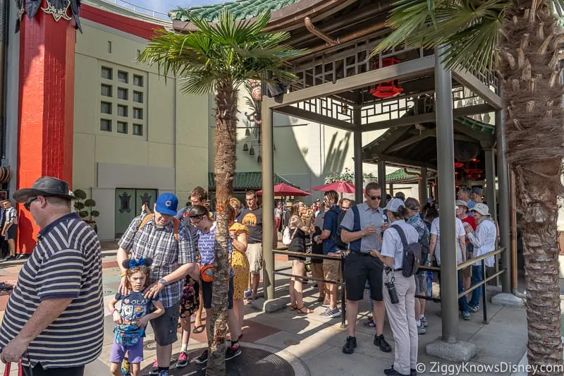 guests in queue outside Mickey and Minnie's Runaway Railway