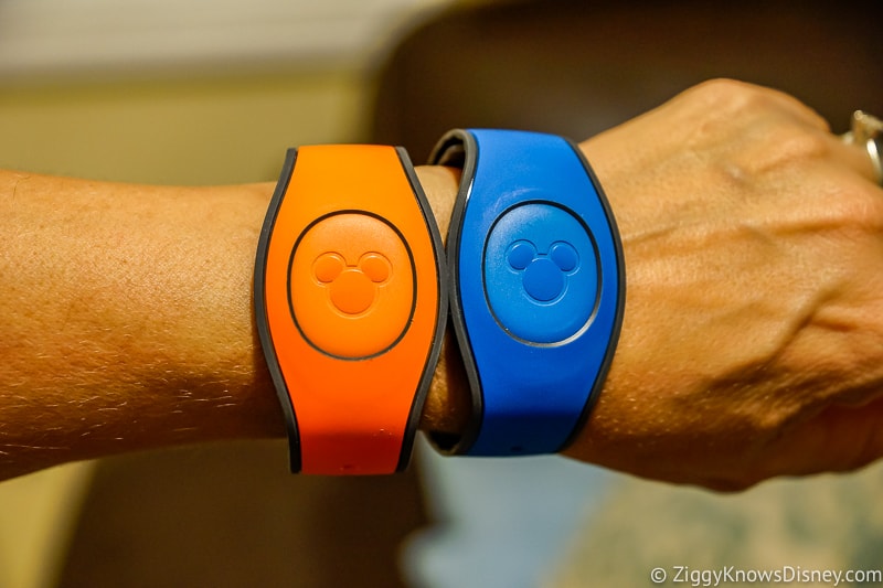 Blue and orange MagicBands on wrist