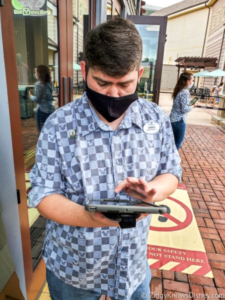 Disney Cast Member taking order for Virtual Queue