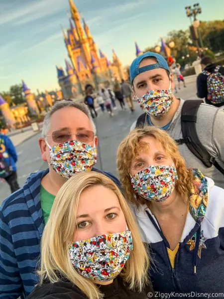 in front of Cinderella Castle Magic Kingdom with masks