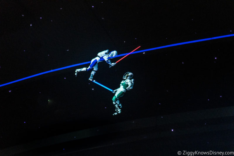 Astronauts fighting with lightsabers in space
