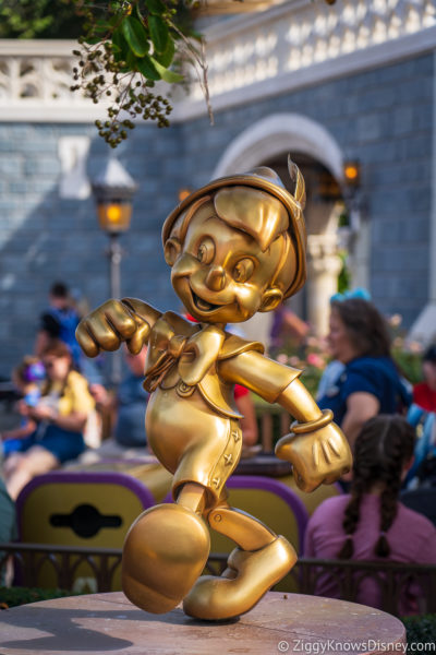 Pinocchio Disney World 50th Anniversary Golden Statues Magic Kingdom