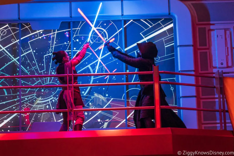 Rey and Kylo Ren fighting with lightsabers on Star Wars: Galactic Starcruiser
