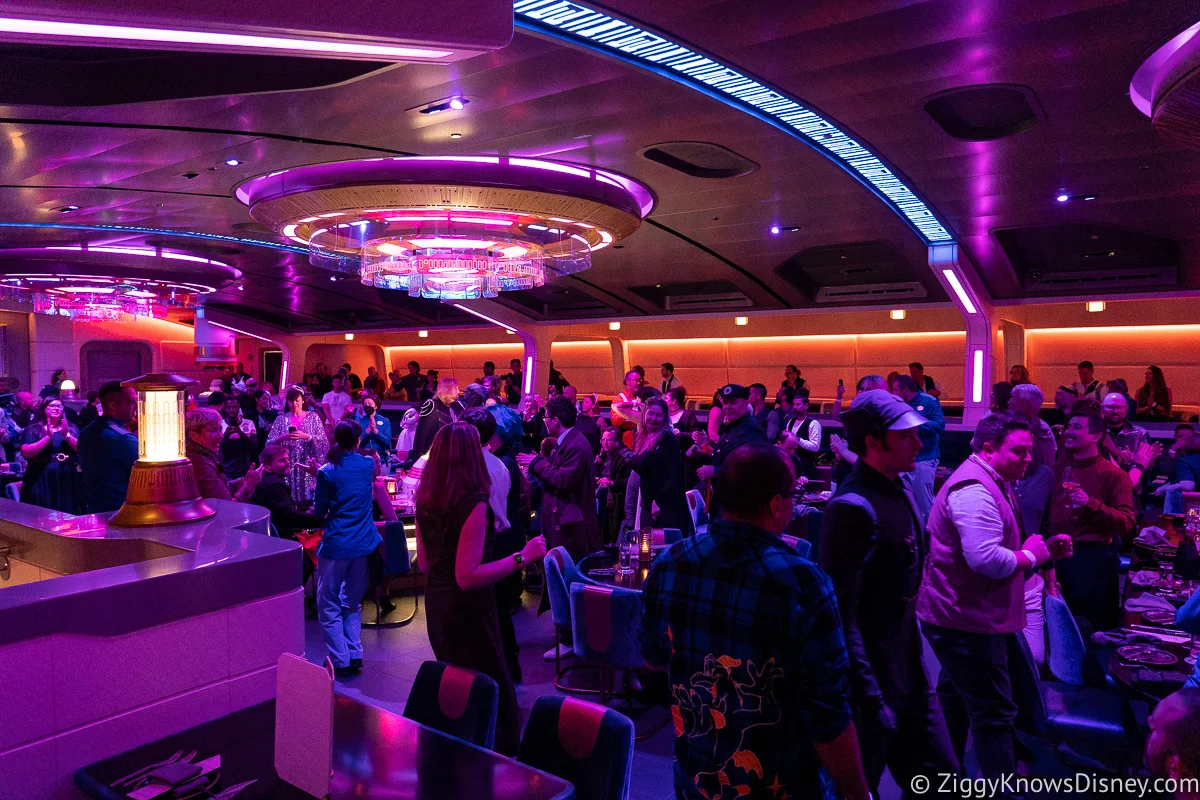 Guests standing and dancing during dinner at Crown of Corellia Dining Room