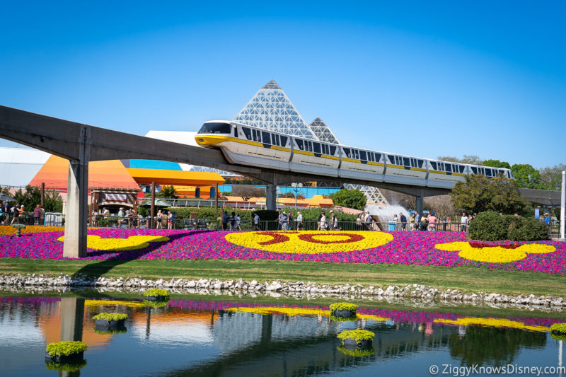 EPCOT during Spring with flowers and Monorail passing Imagination pavilion