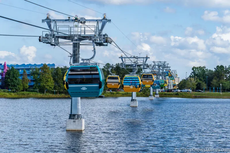 Disney Skyliner moving over a lake in Disney World at Art of Animation and Pop Century