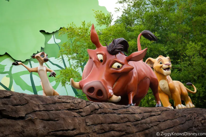 Timon Pumba and Simba at Disney's Art of Animation Resort on a log above the pathway