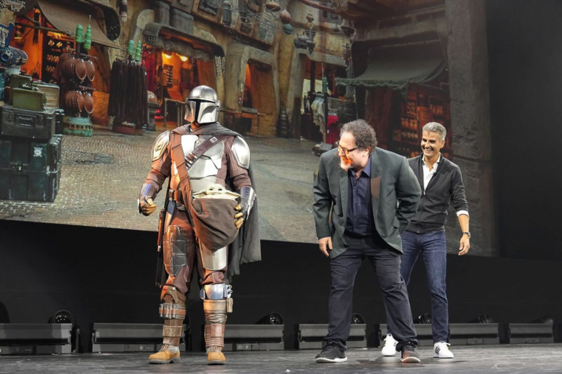 Jon Favreau on stage with The Mandalorian and Grogu