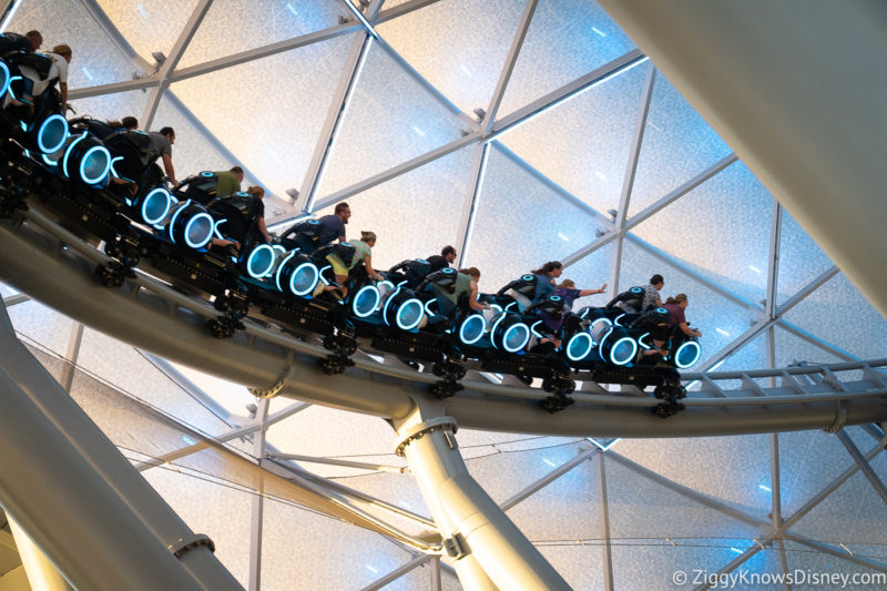 guests riding TRON Lightcycle Run on The Grid outside