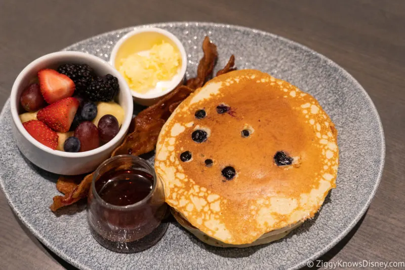 breakfast pancakes with syrup fruit and bacon