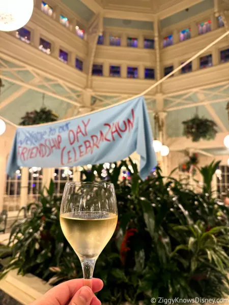 holding a glass of white wine The Crystal Palace