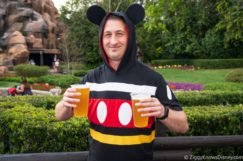 Matt Disney Cast Member dressed up as Mickey Mouse holding beers in his hands at EPCOT
