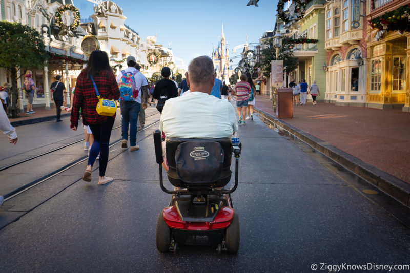 riding a scooter in Magic Kingdom Disney World
