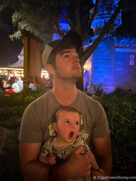 baby and his father watching fireworks