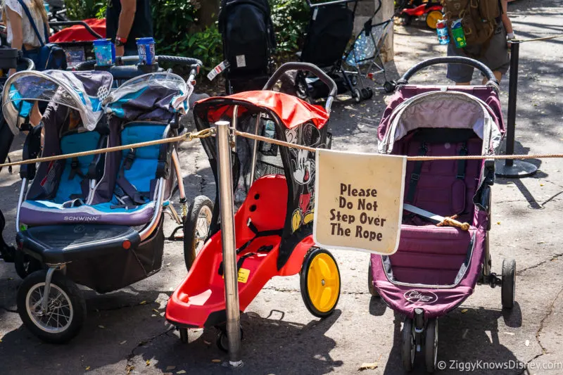 strollers in front of a sign at Disney World