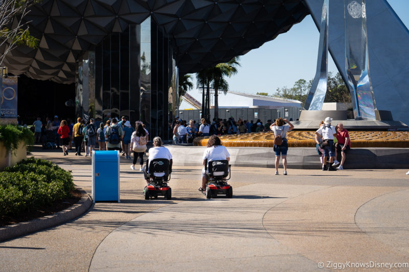 two guests riding scooters at EPCOT