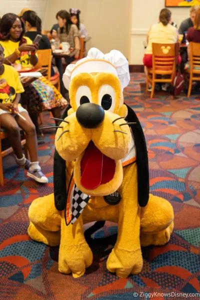 Pluto crouching at Chef Mickey's restaurant