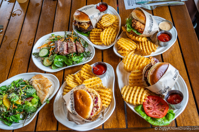 Table full of burgers fries and food at Geyser Point Wilderness Lodge Resort