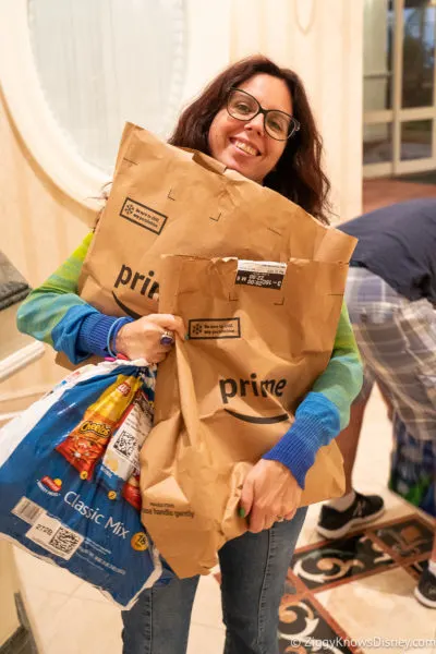 holding up bags groceries from delivery