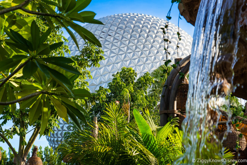 looking at Spaceship Earth through the trees Moana Journey of Water EPCOT