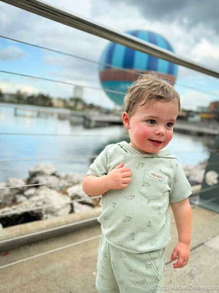 baby in front of the Aerophile baloon Disney Springs
