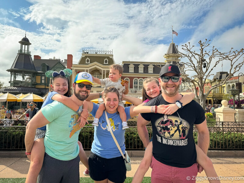 family posing for a photo on Main Street USA Magic Kingdom