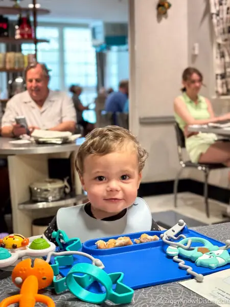 baby sitting at the table at 50's Prime Time Cafe Hollywood Studios